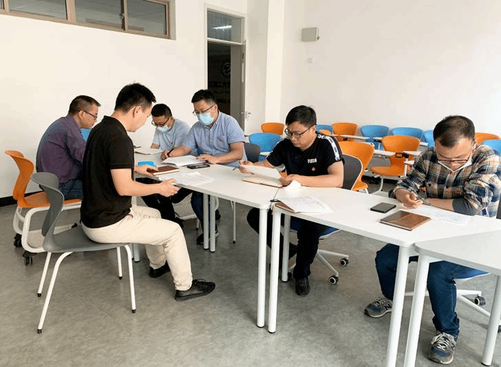 一群人坐在桌子前描述已自动生成